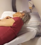 Dementia patient lying on her side for a CT scan of the head.