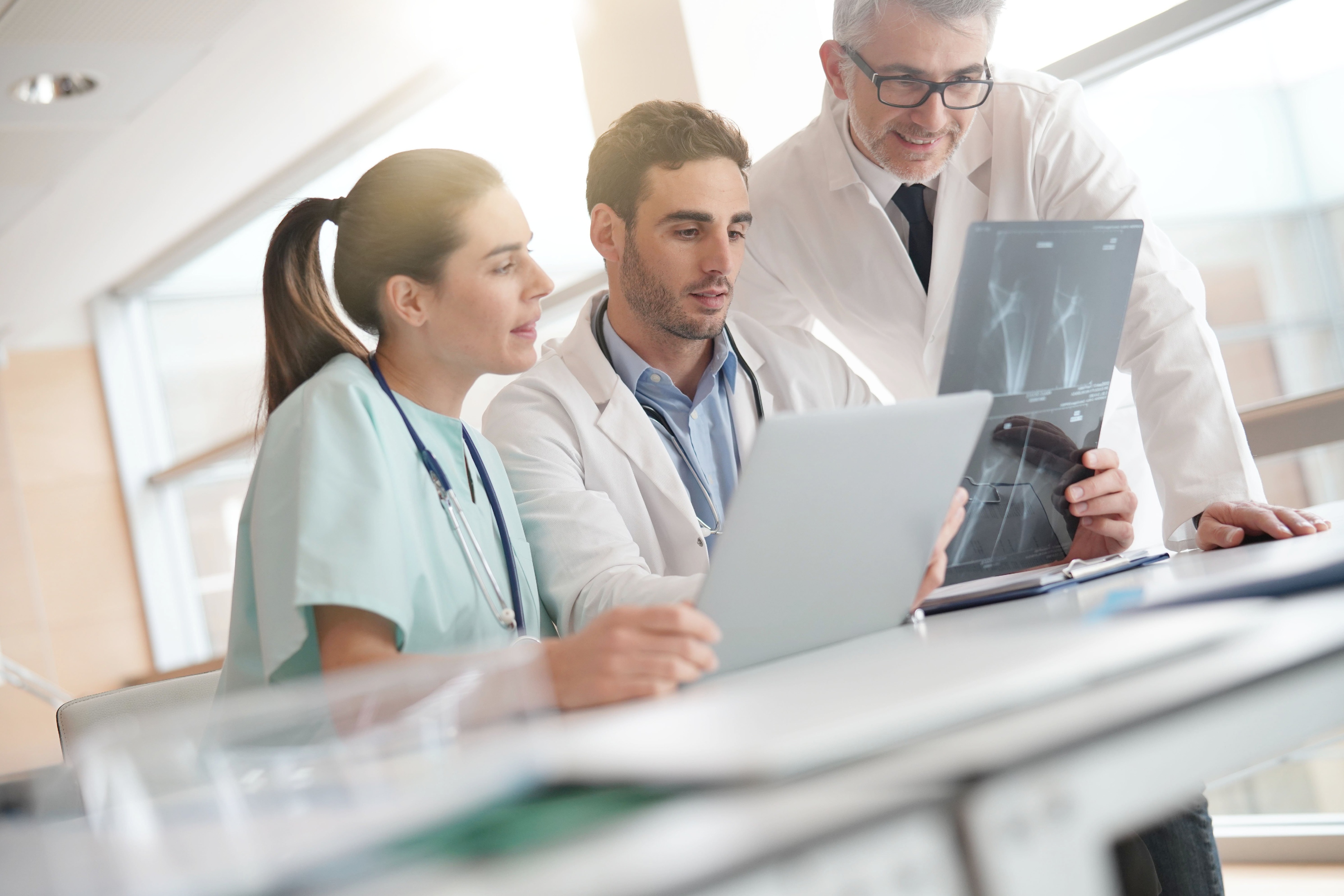 Team of doctors discussing x-ray image